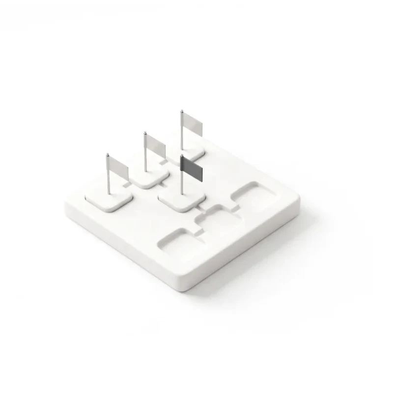 A ceramic board carved with a workflow of step blocks, steel flags in three of them, one flag in graphite.