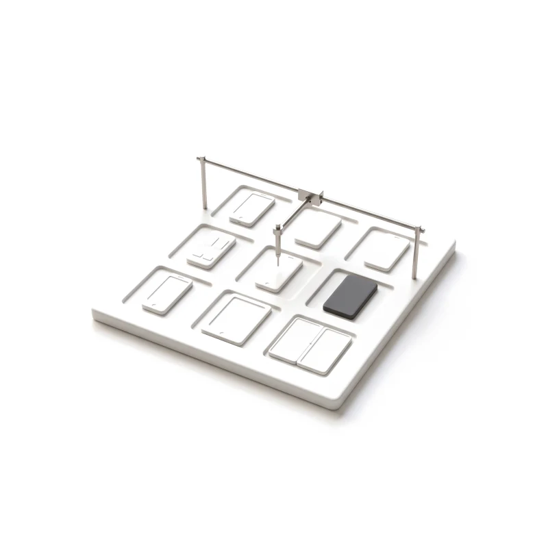 A white ceramic board with a grid of sockets, each holding a different ceramic device, one graphite, a steel gantry lowering a probe onto one of them.