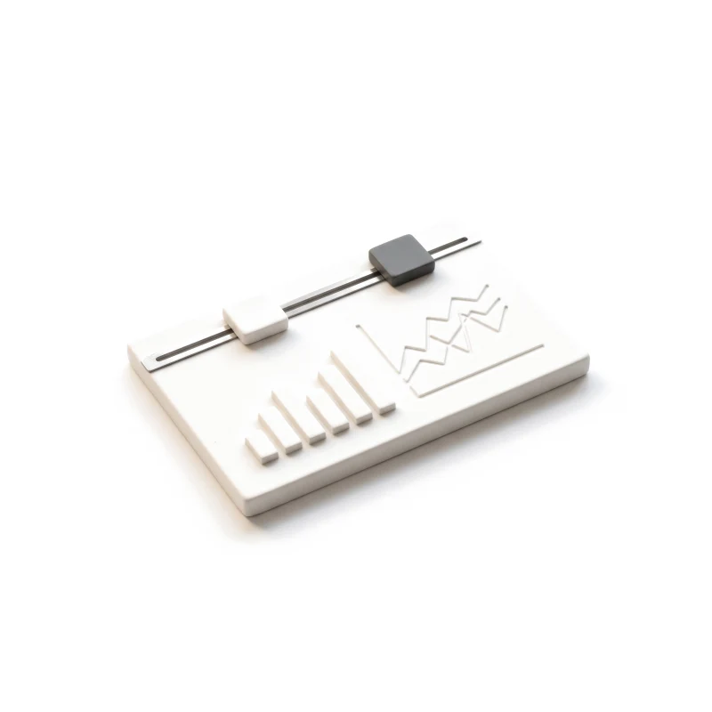 A white ceramic dashboard slab with raised bars and a line chart, a steel range slider with a graphite knob along its edge.