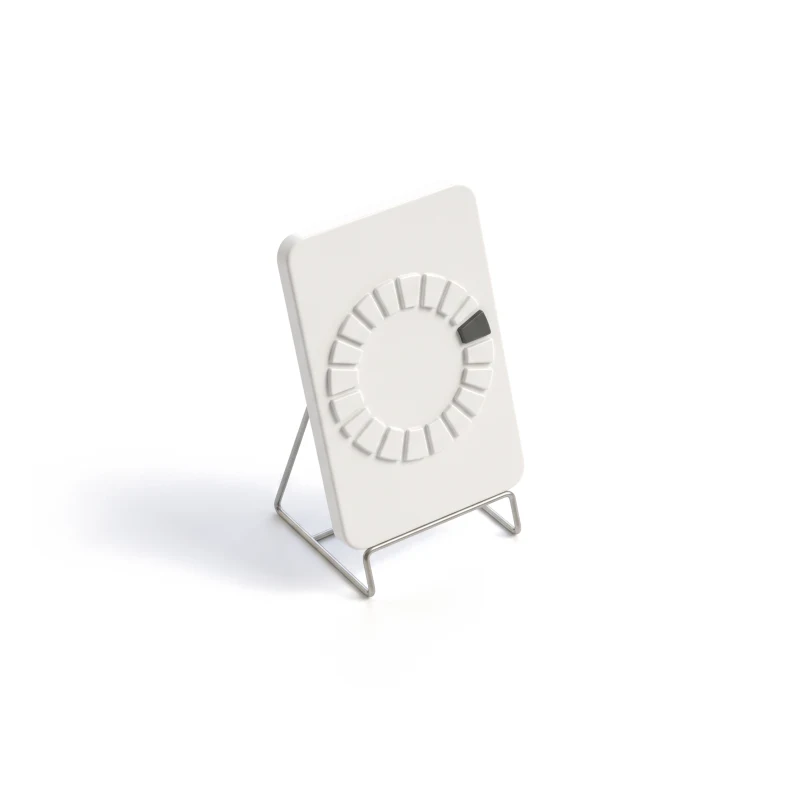 A ceramic phone on a steel stand, carved with a segmented progress ring, one segment graphite.