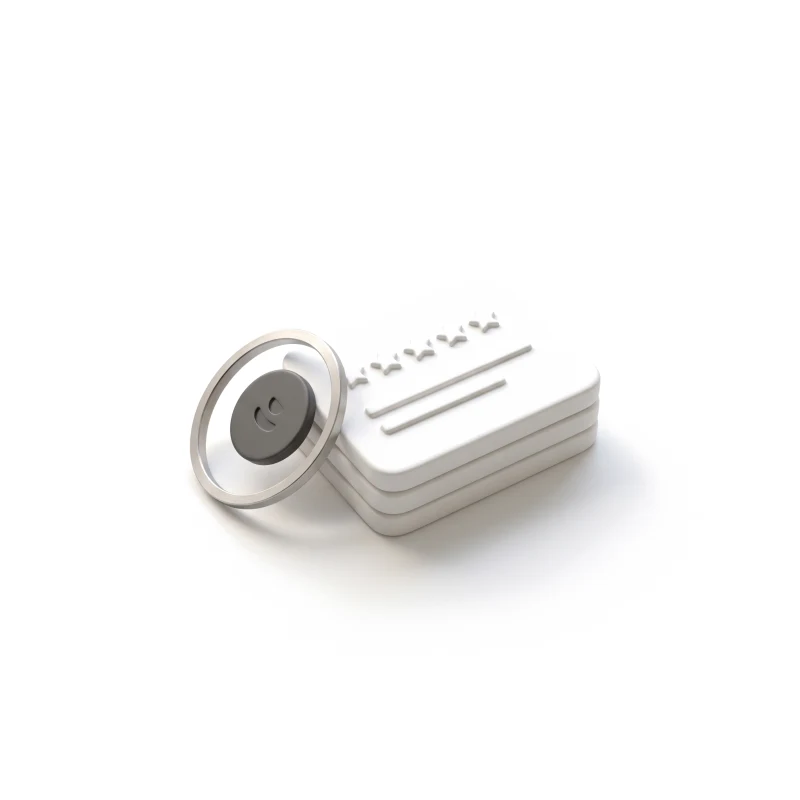 A stack of ceramic review cards with raised stars, a steel ring holding a graphite reward token.