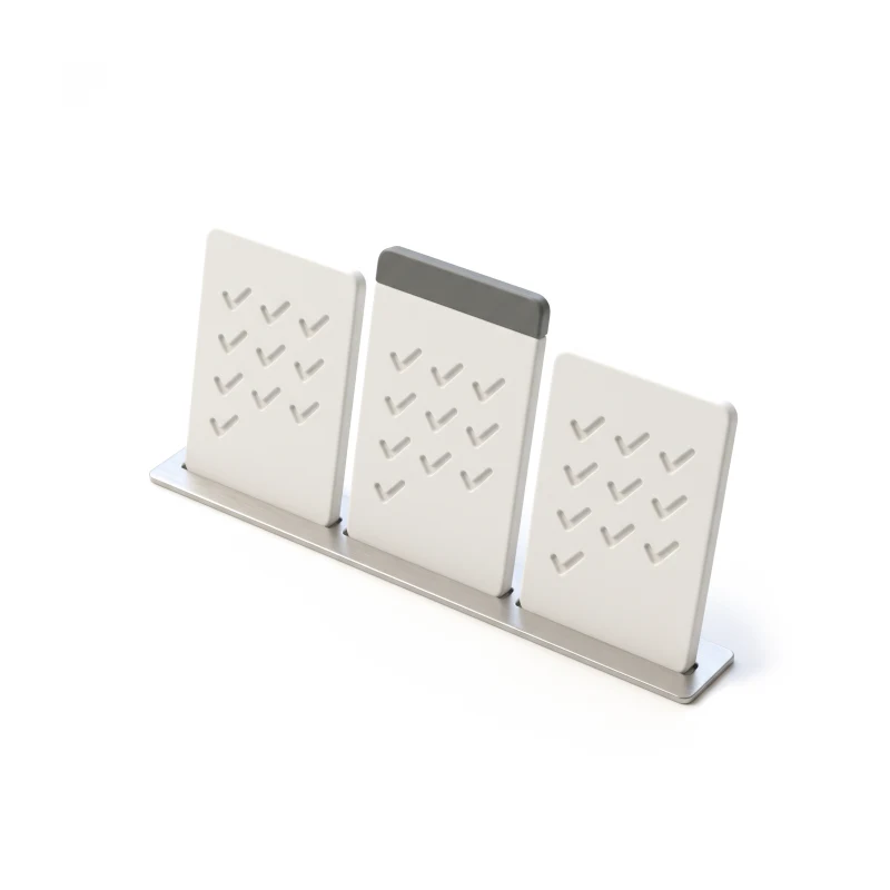 Three white ceramic cards standing on a steel rail, the middle one taller with a graphite band.