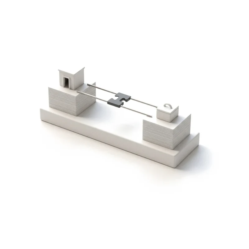 A tiny ceramic building and a small box on card stacks, joined by a steel bridge that interlocks at a graphite joint.