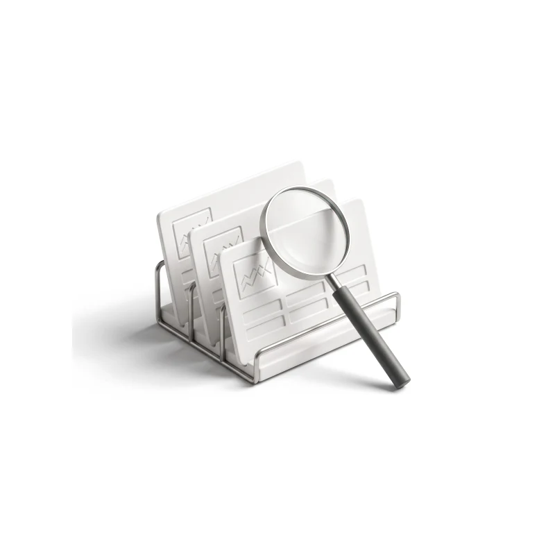 Three ceramic product cards with small charts in a steel rack, a magnifier with a graphite handle leaning on the front one.
