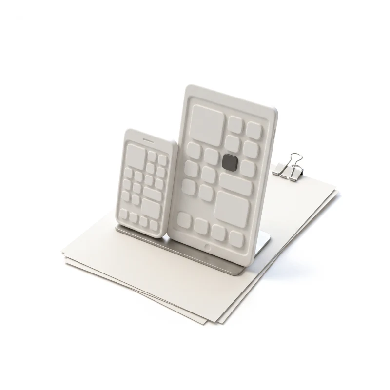 A white ceramic phone and a larger ceramic tablet in one steel stand on a stack of sheets, both screens carrying the same raised layout, one widget tile in graphite.