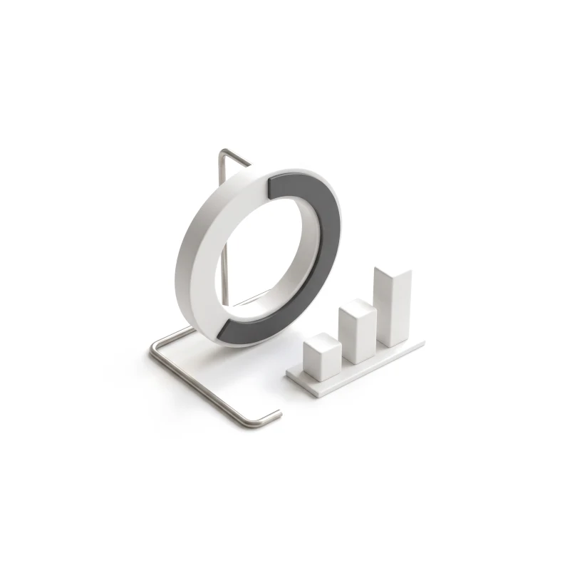 A white ceramic progress ring on a steel stand, its filled arc in graphite, beside three ceramic bar blocks.