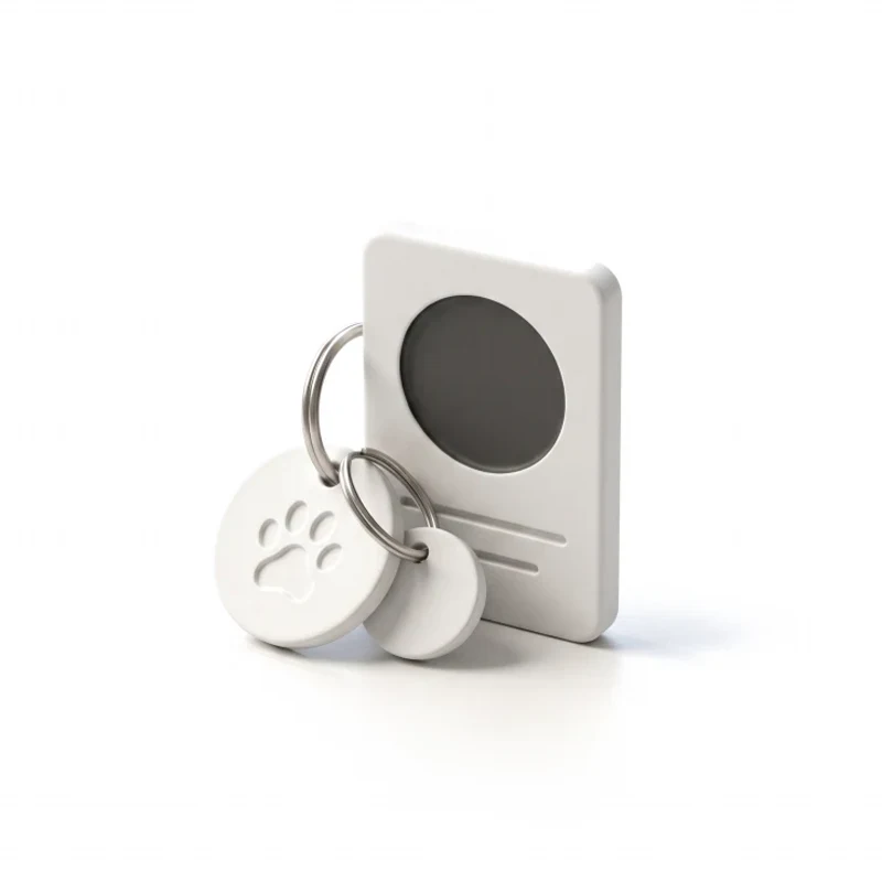 Two ceramic pet tags, one with a paw print, on a steel ring against a profile card with a graphite photo circle.