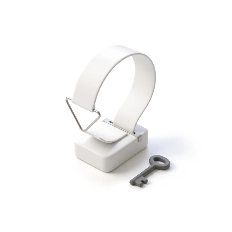 A ceramic receipt printer with its strip looping back on a steel wire, a graphite key lying beside it.