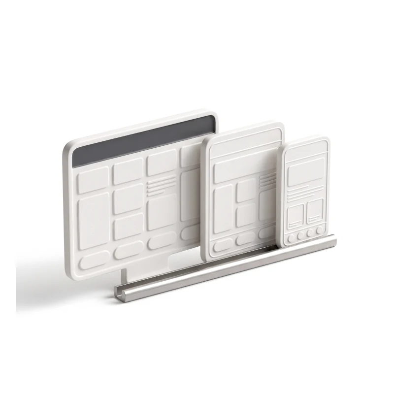 Desktop, tablet and phone slabs in white ceramic on one steel rail, each carved with the same layout reflowed.