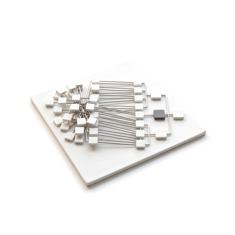 A ceramic base plate with a crowded sitemap tree joined by steel rods to a neat one, one node graphite.