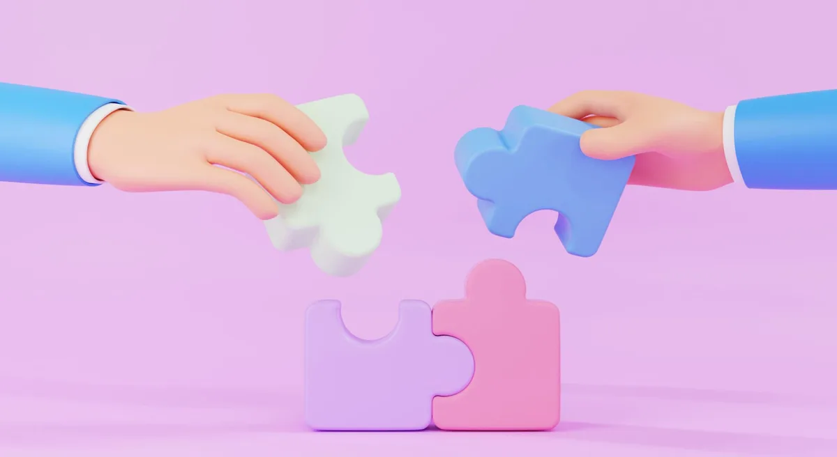 Illustrated hands joining puzzle pieces against a pink background.